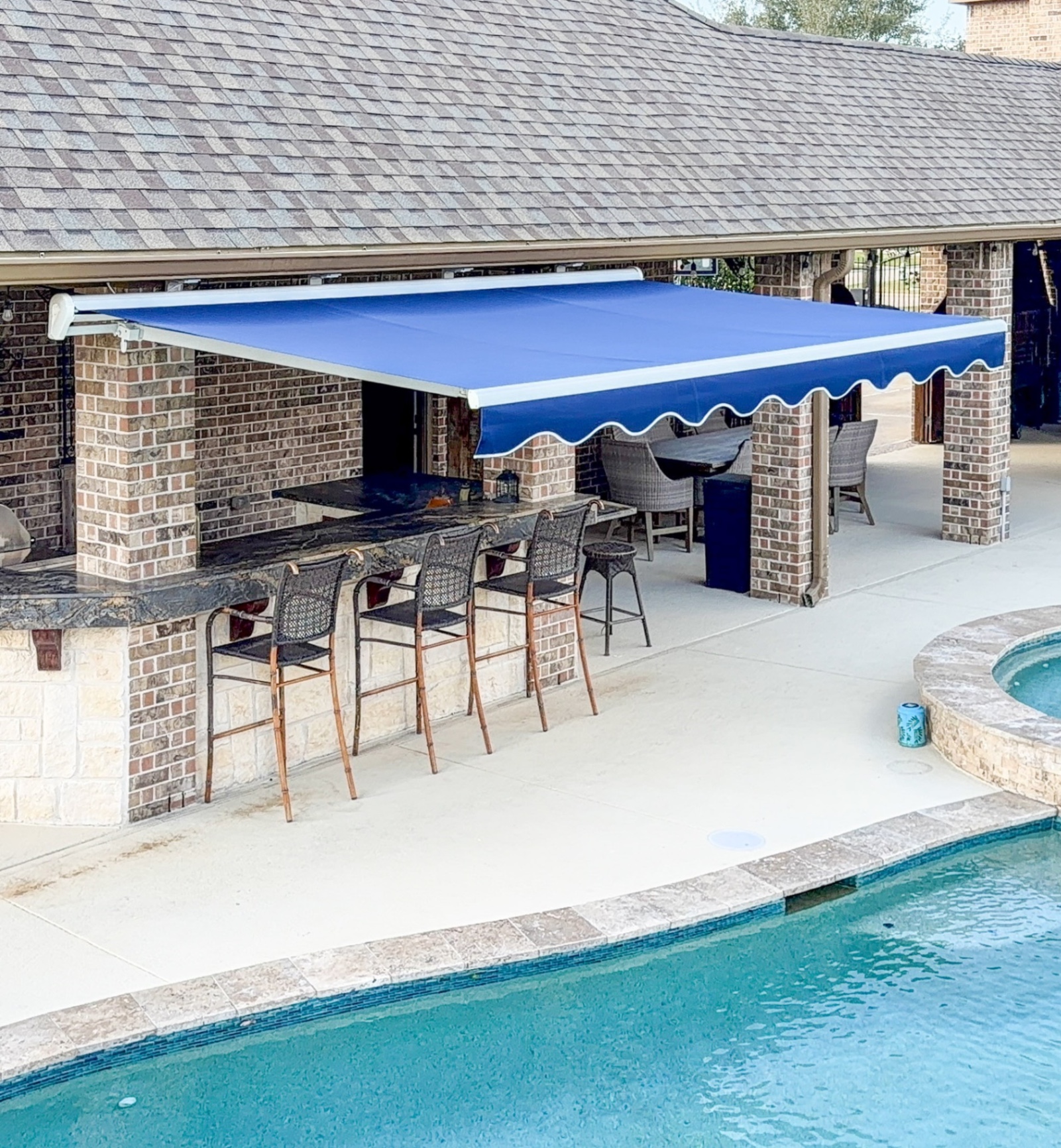 Outdoor Kitchen Retractable Awning installed by Texan Glass in The Woodlands, TX